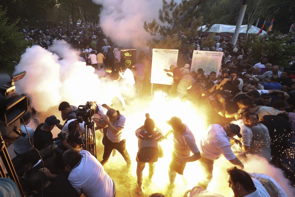A police stun grenade explodes during a rally against Prime Minister Nikol Pashinyan in Yerevan, Armenia on Wednesday. Photo: Vahram Baghdasaryan/Photolure via AP