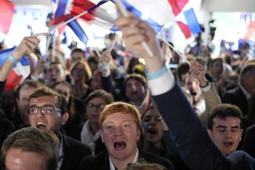 Supporters of the French far-right party, National Rally, react to the European election on June 9 in Paris, France. Photo: AP