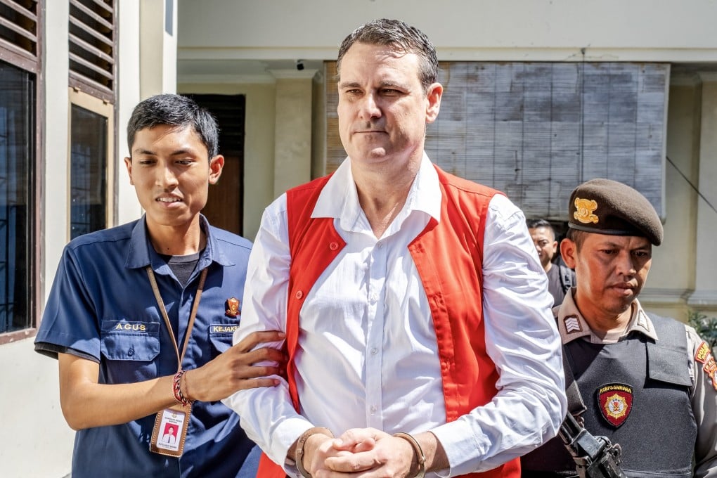 Troy Smith is escorted to his trial, in Bali, Indonesia on Thursday. The Australian was arrested on April 30 by the Indonesian police after being allegedly found in possession of methamphetamine. Photo: EPA-EFE
