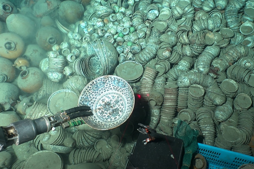 Robotic arms from a research submersible are shown retrieving porcelain relics in the South China Sea. Photo: NCHA