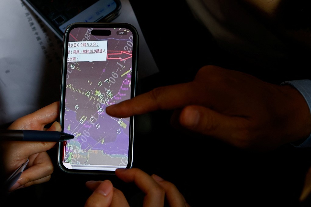A Taiwanese coastguard official indicates to members of the media where the mainland Chinese speedboat entered the Taipei harbour. Photo: Reuters
