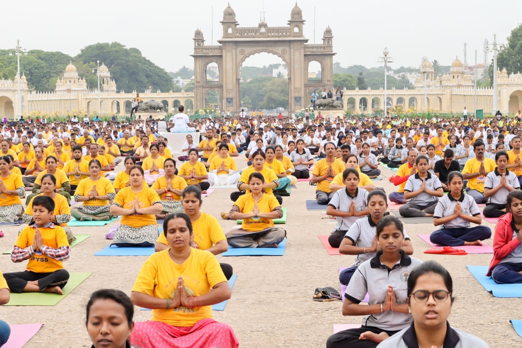 A yoga session in the grounds of Mysore Palace, Mysore. The southern Indian city has become a magnet for aspiring yogis from across the planet. Photo: Shutterstock