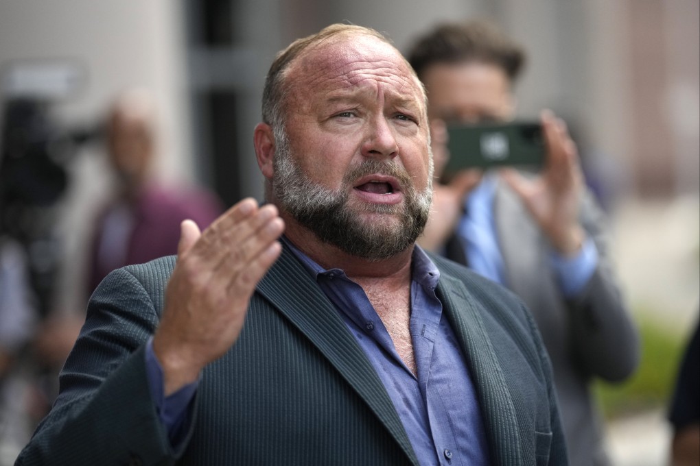US conspiracy theorist Alex Jones speaks to the media after arriving at the federal courthouse in Houston on Friday. Photo: AP