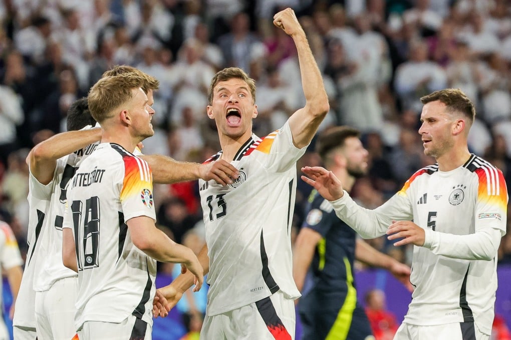 Germany’s Thomas Mueller (centre) celebrates with teammates during the Group A match against Scotland. Photo: dpa