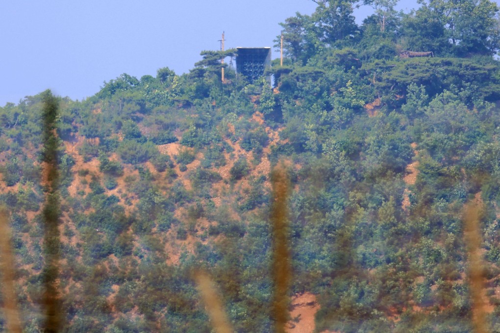 What are believed to be North Korean loudspeakers are seen at the top of a hill, viewed from South Korea’s Ganghwa Island near the Demilitarised Zone (DMZ) dividing the two Koreas on June 11. Photo: via AFP