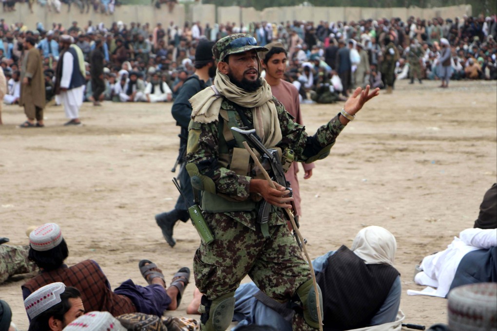 An Afghan Taliban stands guard as people gather to watch local wrestling matches at the Shalamar festival in Kandahar, Afghanistan, in May. Photo: EPA-EFE