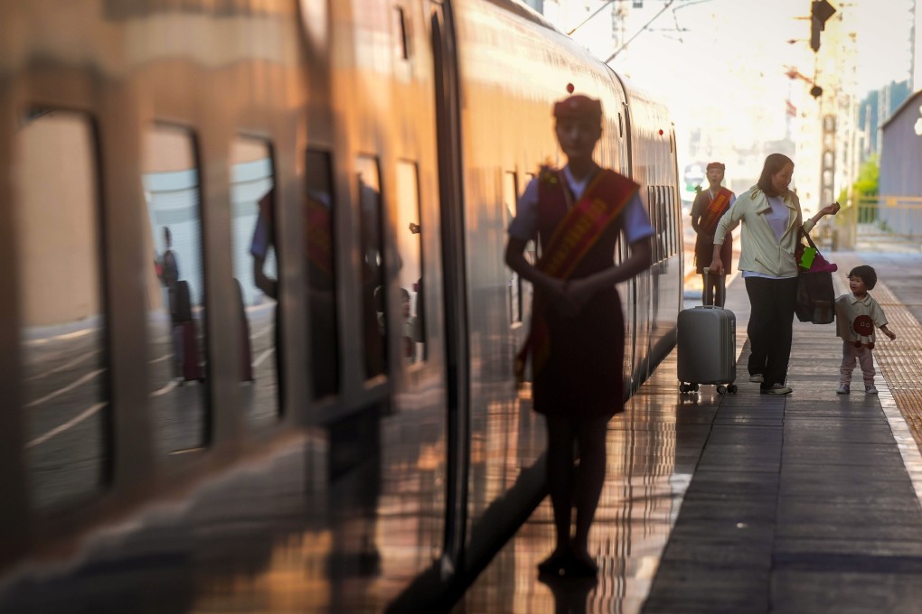 Passengers get off a high-speed sleeper train after it arrives in Beijing. Photo: Elson Li