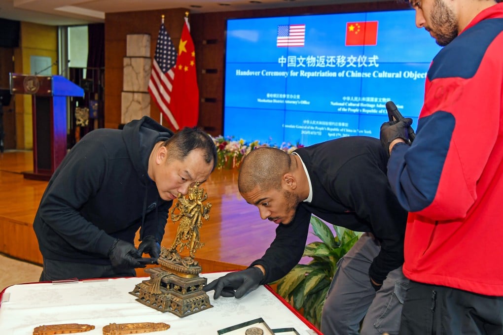 Staff members check the condition of ancient Chinese artefacts at a handover ceremony at the Chinese Consulate General in New York City on April 17. The US has played a useful role in the return of Chinese artefacts to China. Photo: Xinhua