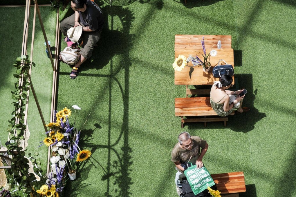 A woman uses a mobile phone inside a mall in Makati City, the Philippines, on May 21. In a country with heavy rain and high temperatures and humidity, big shopping centres are as much a refuge as they are an entertainment destination. Photo: Bloomberg