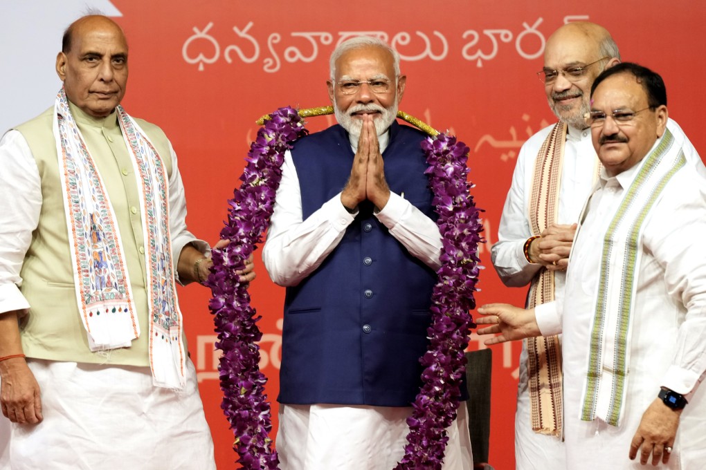 Indian Prime Minister Narendra Modi is garlanded by senior Bharatiya Janata Party leaders. Photo: AP