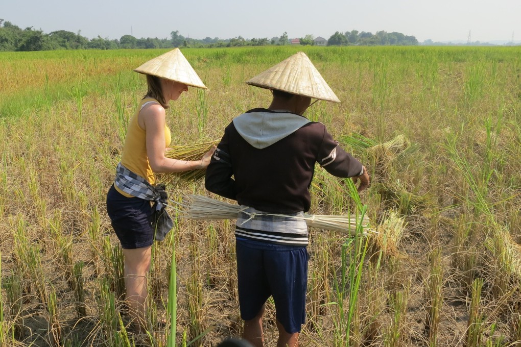 A tourist at Panyanivej Organic Farm in Laos. As well as selling rice and vegetables, the farm now offers guided tours and courses on cookery and ceramic-making. Photo: Somchit Phankham/Handout