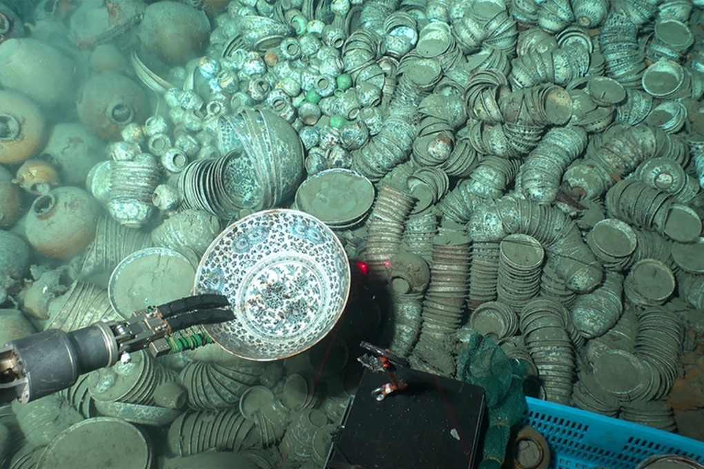 Robotic arms from a research submersible are shown retrieving porcelain relics in the South China Sea. Photo: NCHA