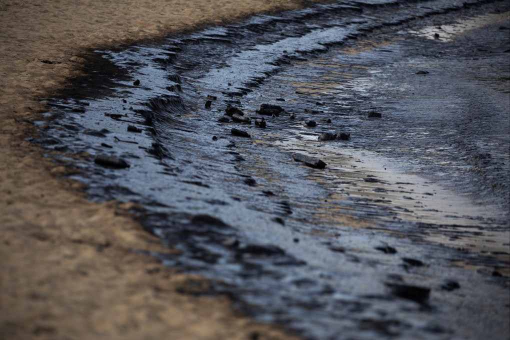 An oil slick is seen on Monday at Tanjong Beach, Singapore’s Sentosa Island, resulting from the collision at sea. Photo: EPA-EFE