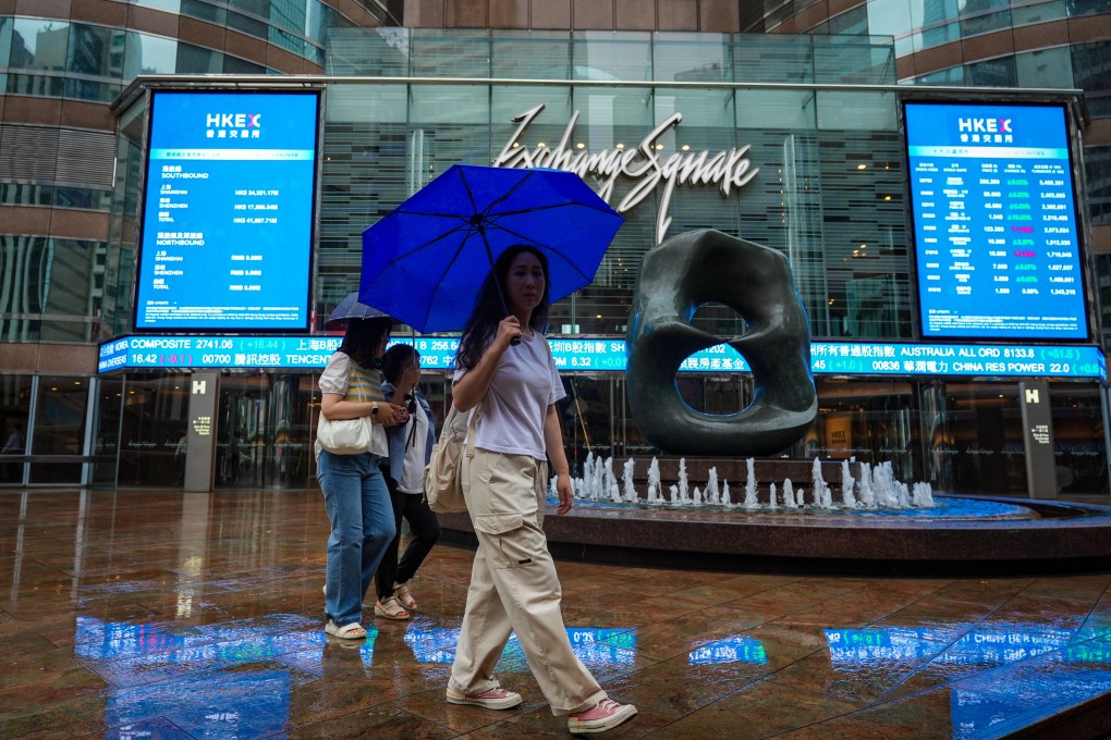 Pedestrians walk past Exchange Square in Central amid rainy and gusty conditions. Photo: Eugene Lee