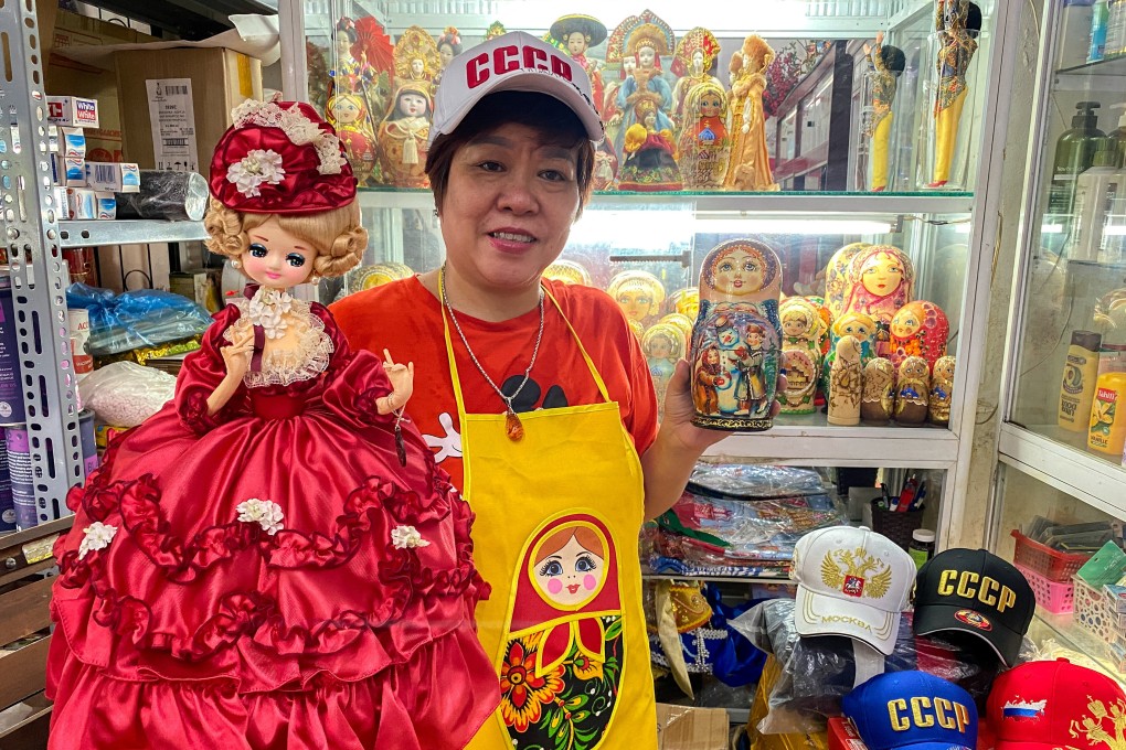 Nguyen Thi Hong Van, a collector and seller of Russian souvenirs, poses at her shop in Hanoi. Photo: Reuters