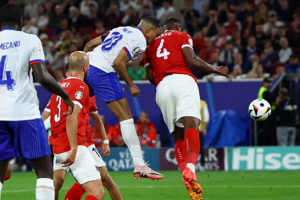 France’s Kylian Mbappé collides with Austria’s Kevin Danso during the Group D match between France and Austria on Monday. Photo: Reuters