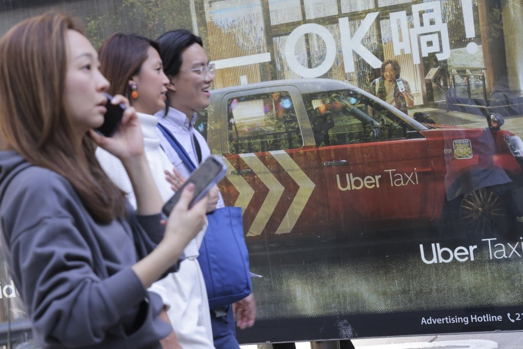 Pedestrians walk past an Uber Taxi advertisement on Nathan Road in Tsim Sha Tsui on November 21, 2023. Photo: Jelly Tse