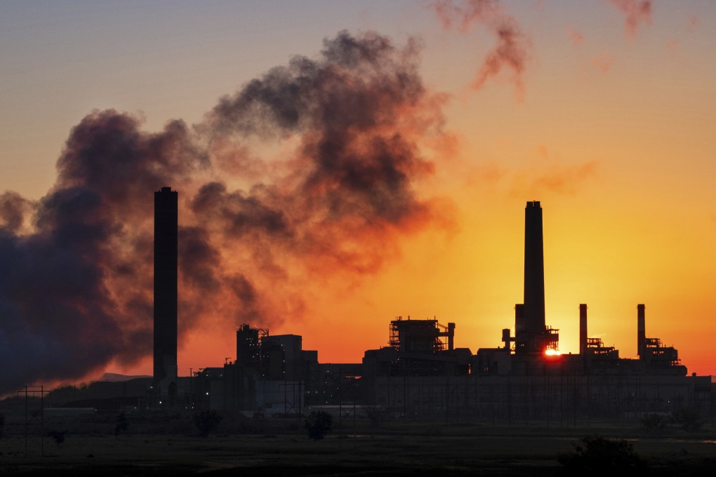 A coal-fired power plant is silhouetted against the morning sun. A report says that air pollution can be linked to the death of almost 2,000 children daily. Photo: AP