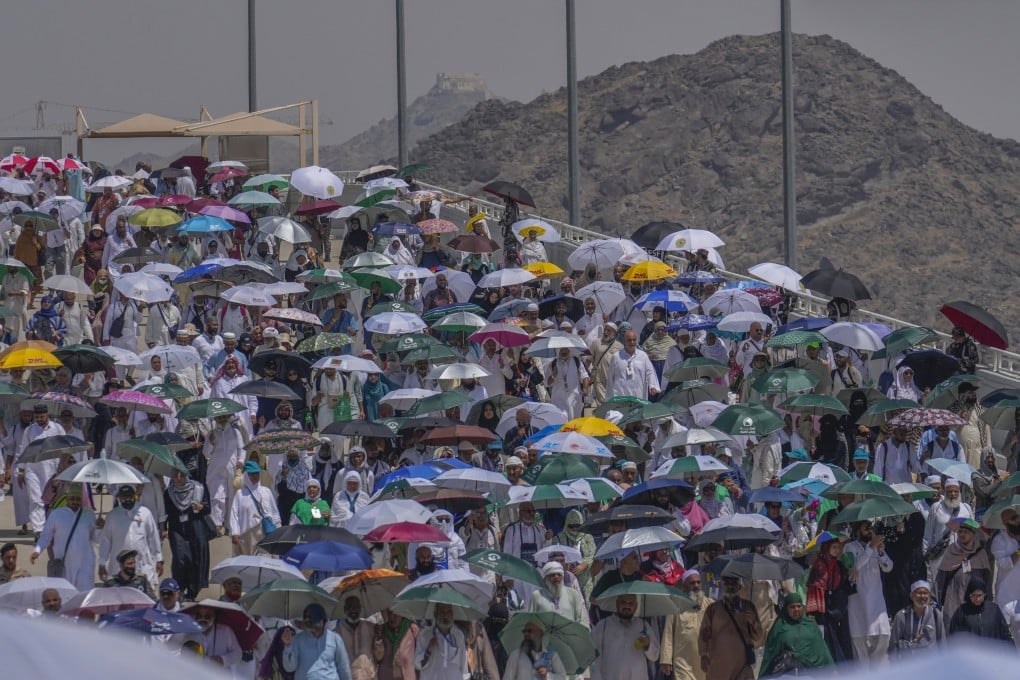 Muslim pilgrims use umbrellas to shield themselves from the sun. Photo: AP