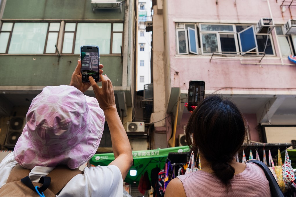 Participants on a Hong Kong walking tour with City Unseen photograph quirky architecture in Prince Edward. The group plans a series of tours to encourage deeper engagement with the urban landscape. Photo: Joshua Wolper