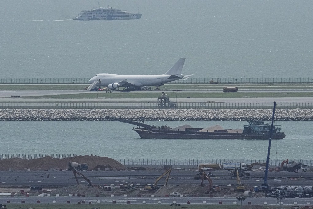 A cargo plane, which burst a tyre during an emergency landing at Hong Kong International Airport, is seen parked on the north runway. Photo: May Tse