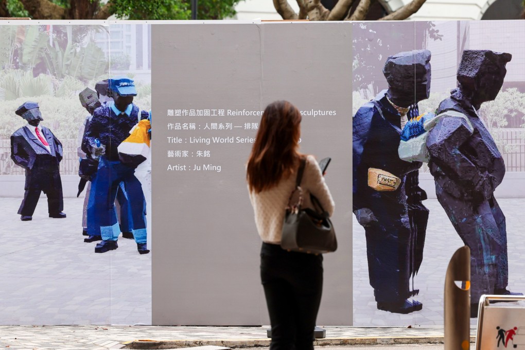 One of the grey panels covering part of a photo of the artwork where two figures in yellow raincoats would have been seen. Photo: Jelly Tse
