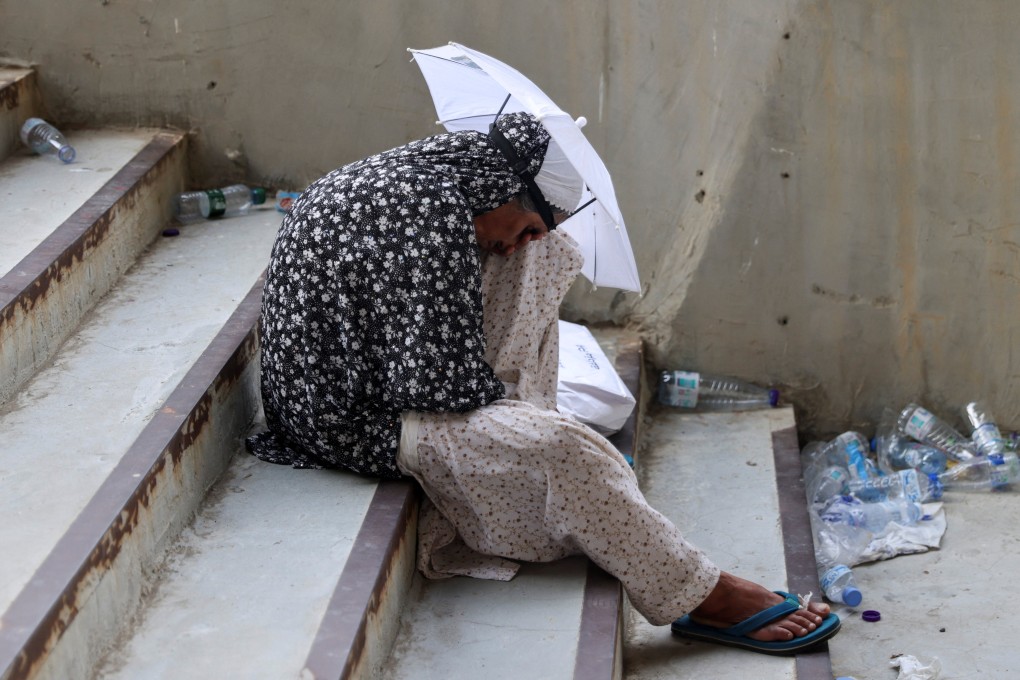 A Muslim pilgrim in Saudi Arabia uses an umbrella as a sun shield amid hot weather during the annual haj pilgrimage on Sunday. Photo: Reutes