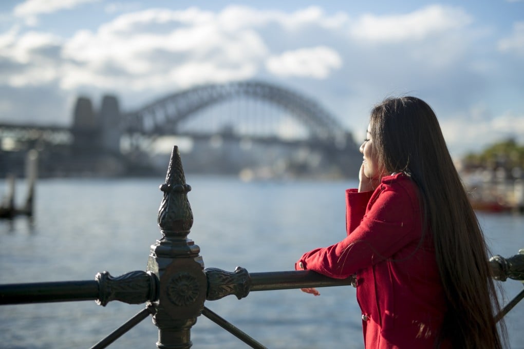 A woman takes in the view of Sydney Harbour Bridge. Single Chinese women in their thirties are leaving behind what they consider lives of little hope in China to study in Western countries, as part of a “run philosophy” that has gripped social media. Photo: Getty Images