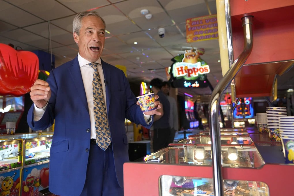 Reform UK party leader Nigel Farage plays on a game in an amusement arcade in Essex, England, on June 21. Photo: AP