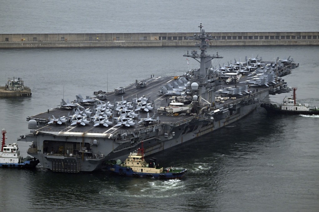 The USS Theodore Roosevelt, a nuclear-powered aircraft carrier, is anchored in Busan, South Korea, on Saturday. Photo: Pool via AP