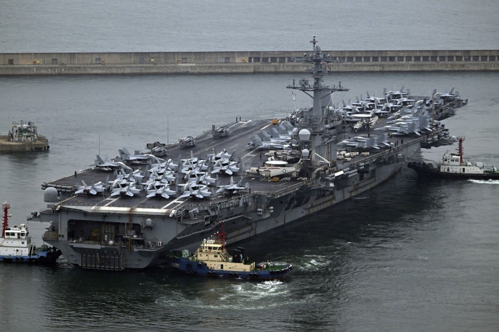 The USS Theodore Roosevelt, a nuclear-powered aircraft carrier, is anchored in Busan, South Korea, on Saturday. Photo: Pool via AP