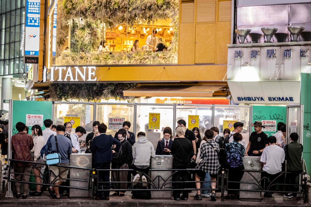 People gather around a smoking area in Tokyo, Japan. Photo: AFP