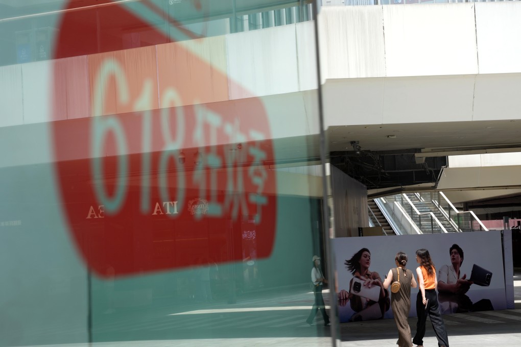 People walk past a promotional sign for the 618 shopping festival at a shopping mall in Hangzhou. Photo: Xinhua
