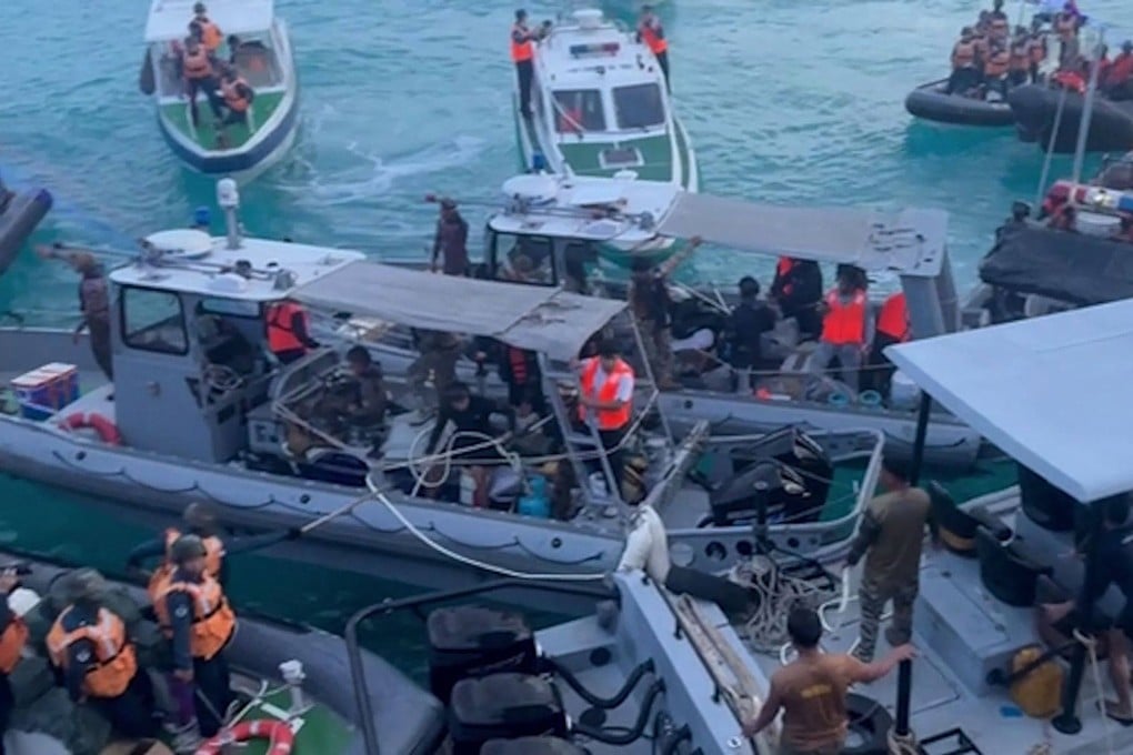 Chinese coastguard personnel (left and right) aboard their inflatable boats blocking Philippine navy boats (centre) in the disputed South China Sea on June 17. Photo: AFP