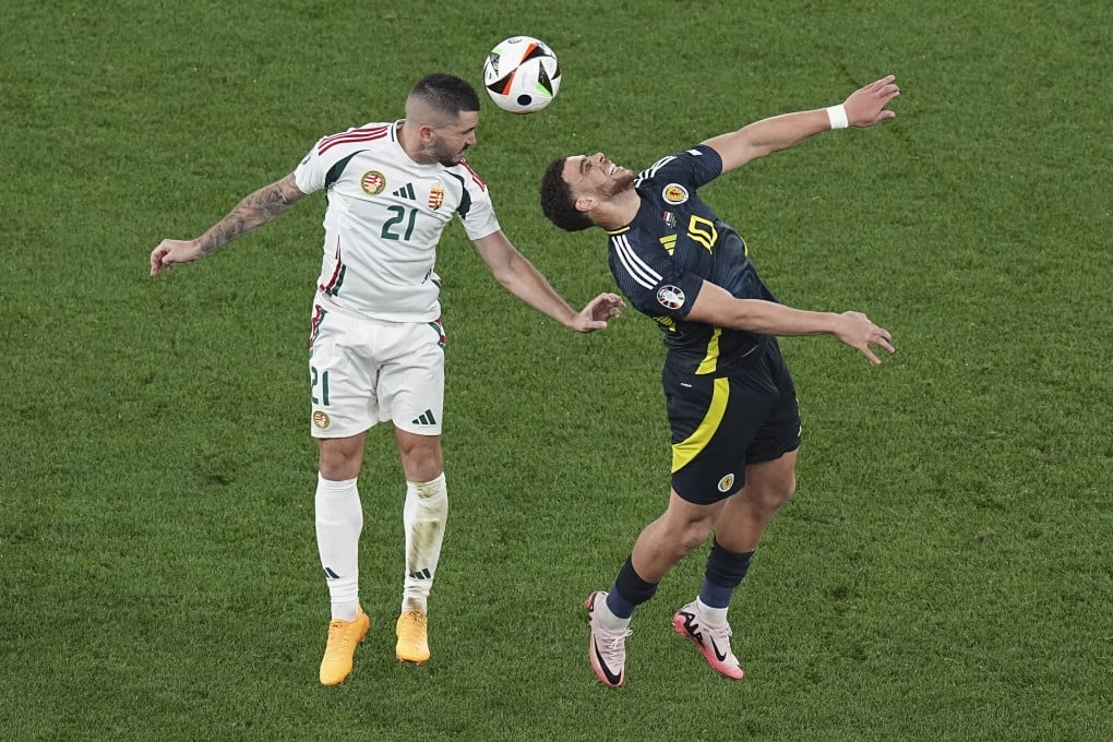 Hungary’s Endre Botka, left, heads the ball over Scotland’s Che Adams during the Euro 2024 in Stuttgart, Germany on Sunday. Photo: AP