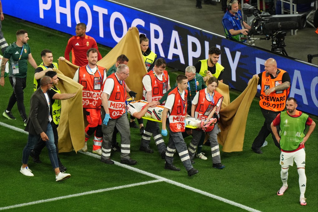Hungary’s Barnabas Varga is stretchered off after suffering a sickening injury during the win over Scotland. Photo: DPA