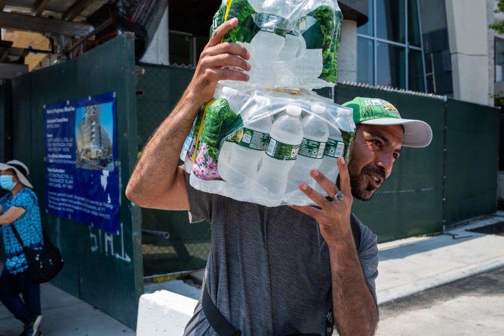 A vendor carries cases of water at Coney Island on a sweltering afternoon in New York at the weekend. Photo: Getty Images / TNS