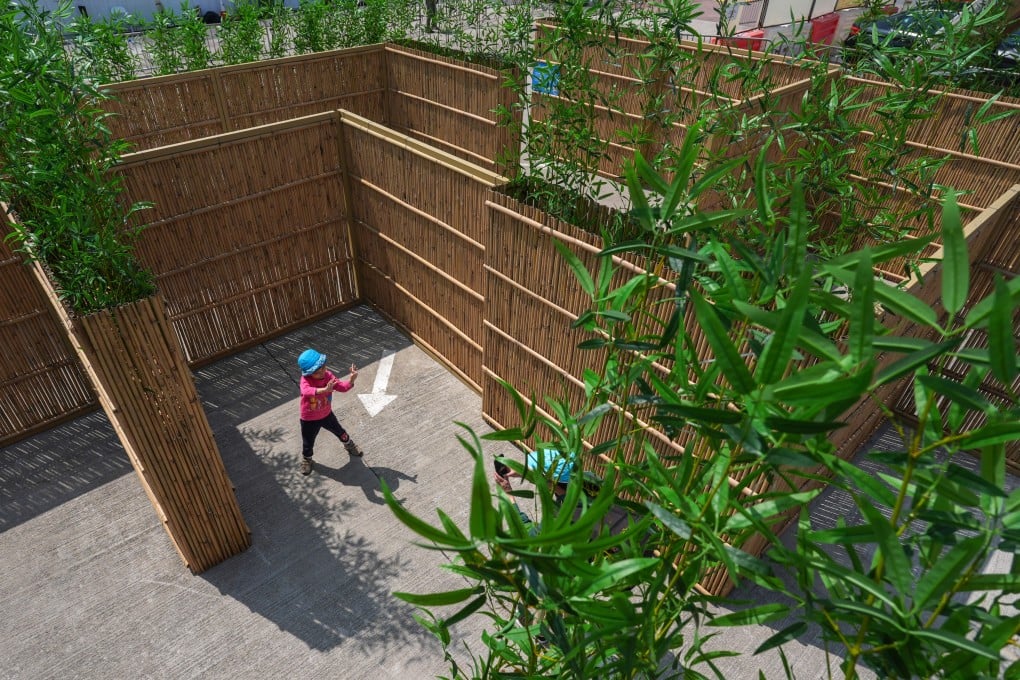 Visitors pose for photos inside the “Lost in the Woods” bamboo-themed maze, during an event at Wan Chai Harbourfront Event Space in Hong Kong on March 20, 2024. Photo: Eugene Lee