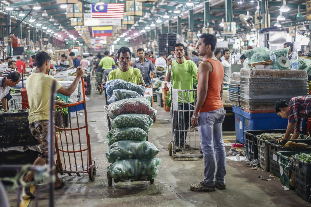 Labourers from Bangladesh and Myanmar work at a wholesale market in Kuala Lumpur, Malaysia. Photo: Shutterstock