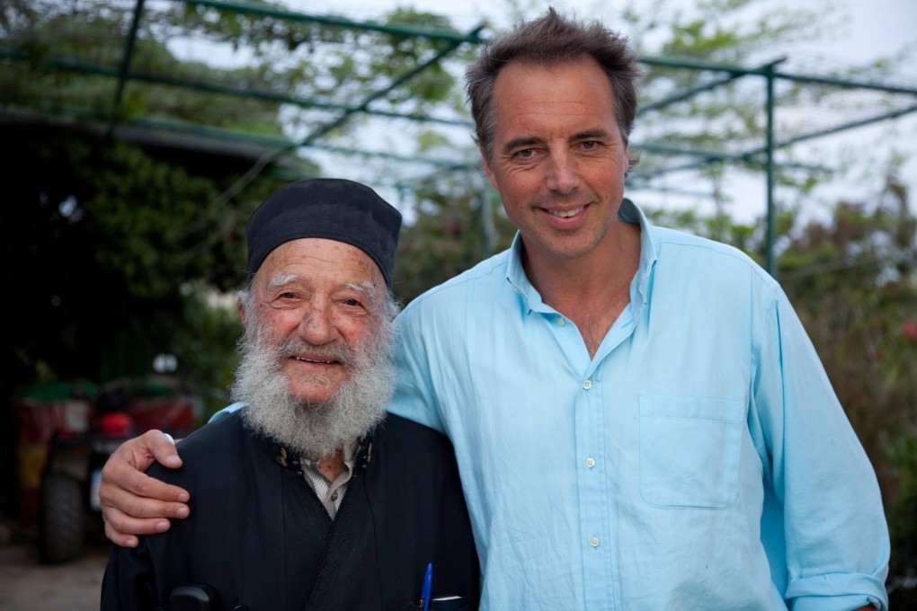 Dan Buettner with a 93-year-old Greek Orthodox priest on the Aegean island of Ikaria, in Greece. There are no magic solutions to long life, says Buettner, who coined the term ‘blue zones’ for communities with healthy centenarians. Photo: David McLain