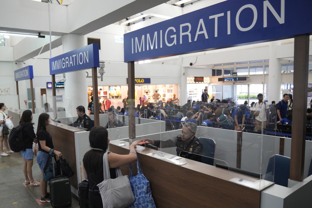 Immigration officers check passengers’ passports at a ferry terminal on Indonesia’s Bintan Island in May. Photo: AP