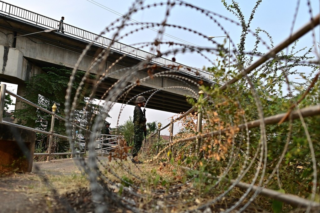 A member of Thai military personnel stands guard in Mae Sot district overlooking the Moei River that forms the border with Myanmar. Photo: AFP