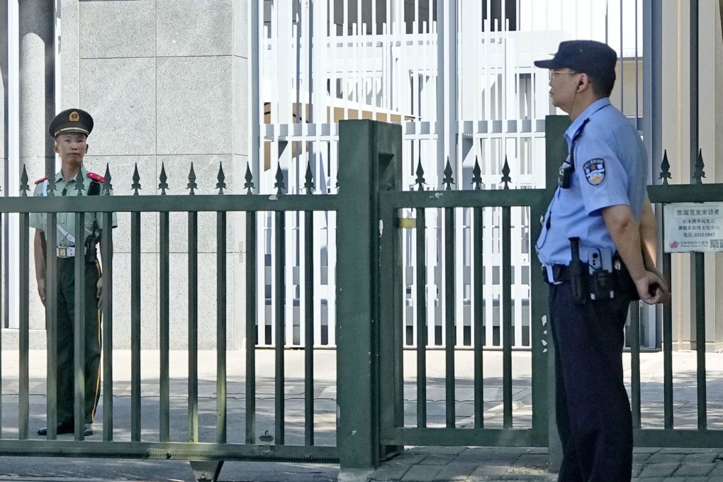 Security officers stand guard in front of the Japanese embassy in Beijing on Tuesday, a day after a Japanese woman, her son and a Chinese woman were stabbed by a man at a school bus stop in Suzhou near Shanghai. Photo: Kyodo
