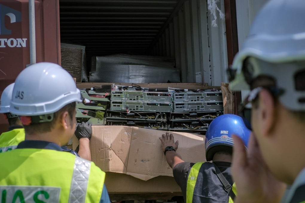 Malaysian officials examine a seized container filled with e-waste that originated from the Los Angeles port. Photo: Natural Resources and Environmental Sustainability Ministry