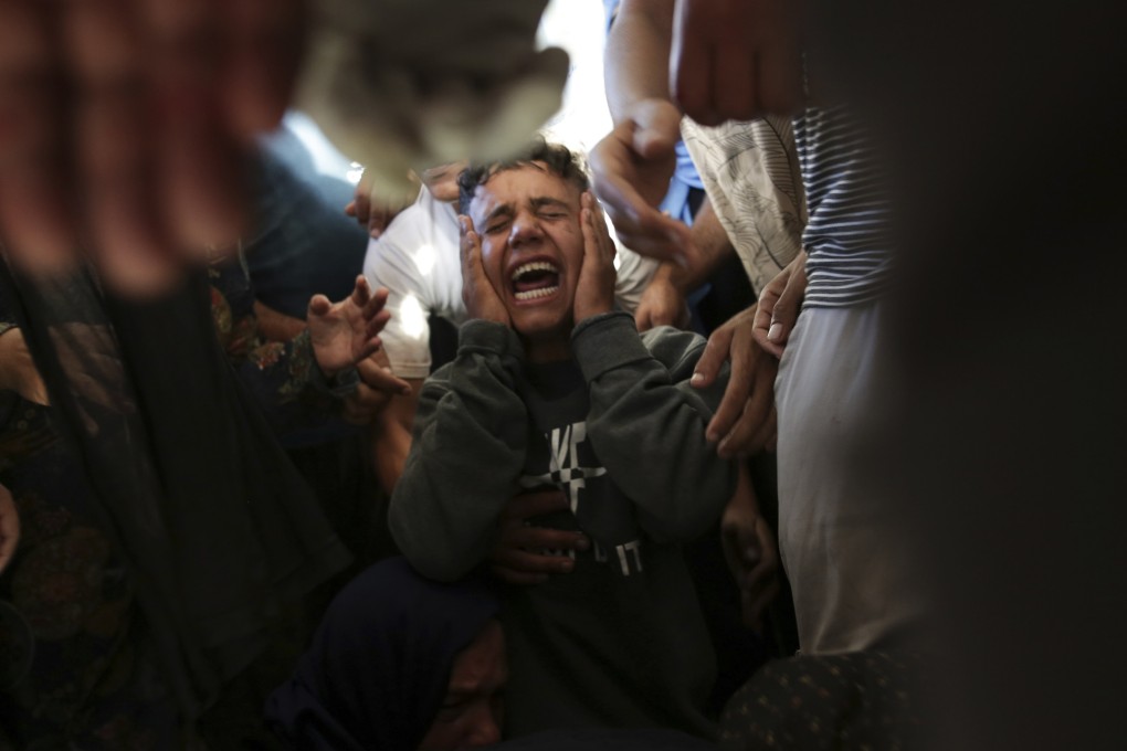 Palestinians at a hospital morgue in Khan Younis mourn relatives killed in an Israeli bombardment of the Gaza Strip. Photo: AFP