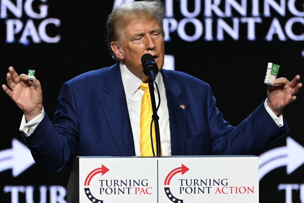 Former US President and 2024 Republican presidential candidate Donald Trump holds a big and a small box of tic-tac to illustrate inflation during a campaign event in Phoenix on June 6. Photo: AFP