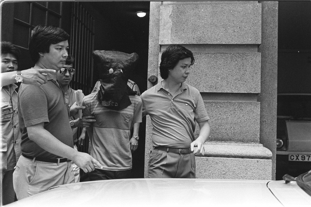 Cheung Sai-hung (centre), one of the three men accused of murdering two Pakistani security guards and robbing  King Fook Gold and Jewellery in 1983, is escorted to court in Hong Kong by police. Photo: SCMP