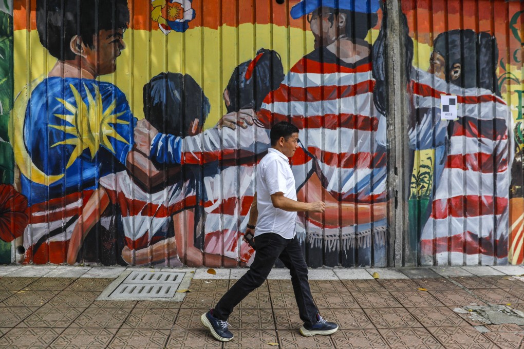 A pedestrian walks past a mural in Kuala Lumpur, Malaysia on June 1, 2023. While Malaysia has expressed support for joining Brics, it maintains close ties with the United States. Photo: EPA-EFE