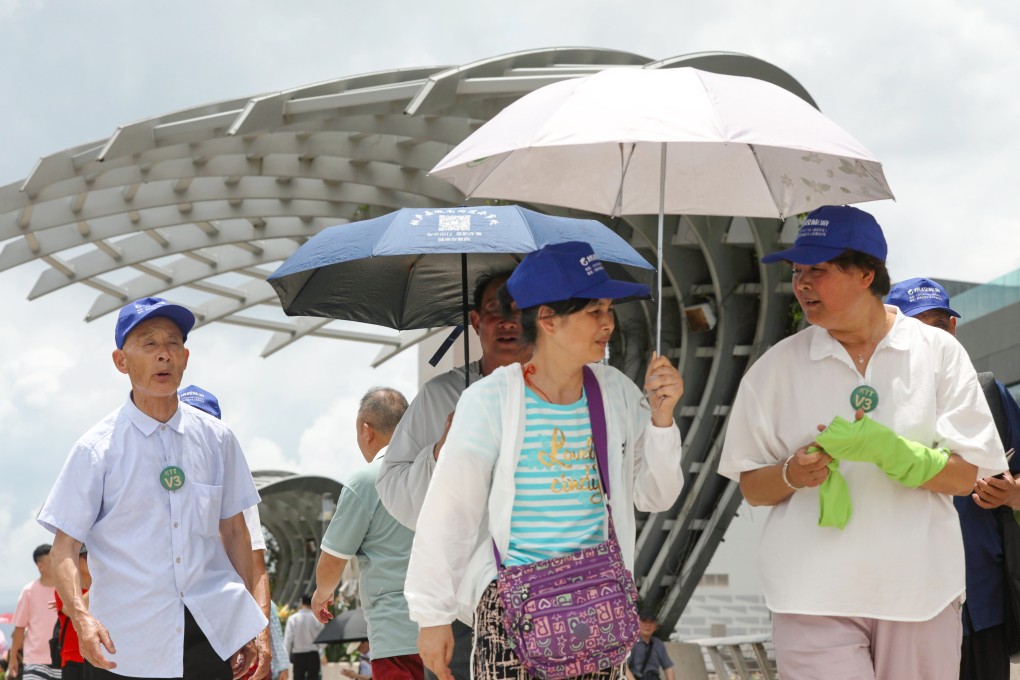 People use umbrellas to shield themselves from the heat. Photo: Sun Yeung