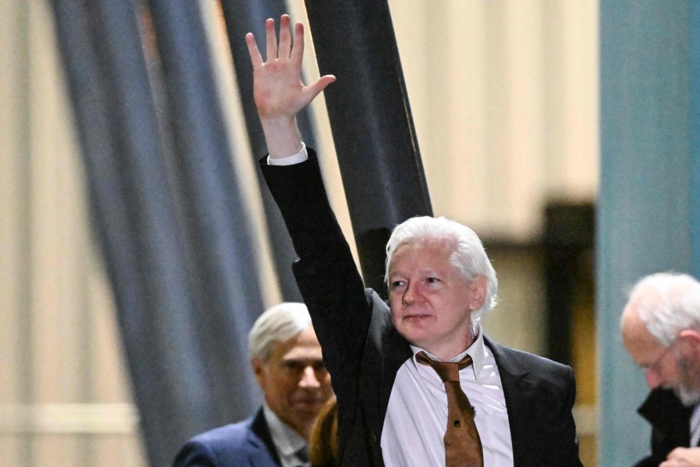 WikiLeaks founder Julian Assange waves after arriving at Canberra Airport in Canberra on Wednesday. Photo: AFP